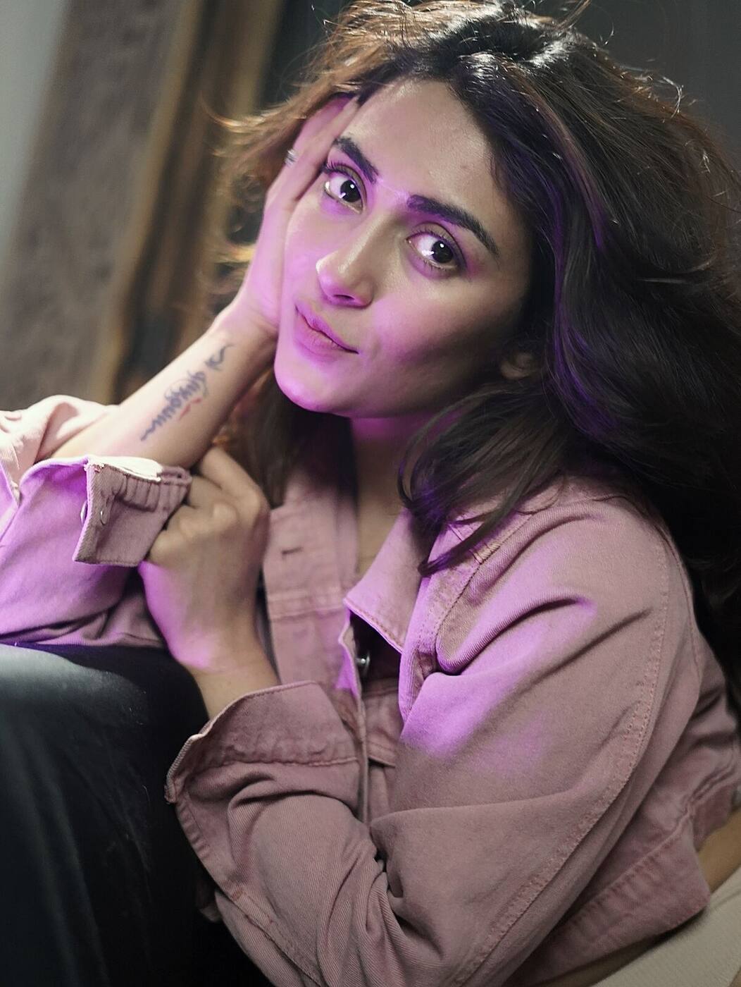 Jinal Joshi, portrait in warm light, hand resting at her cheek